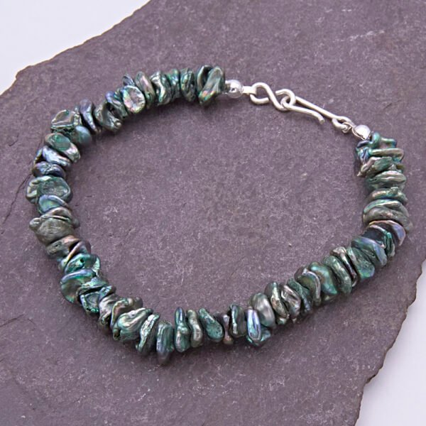 Green Keishi Cornflake Freshwater Pearl and Sterling Silver Bracelet, shown laid on dark slate