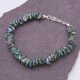 Green Keishi Cornflake Freshwater Pearl and Sterling Silver Bracelet, shown laid on dark slate