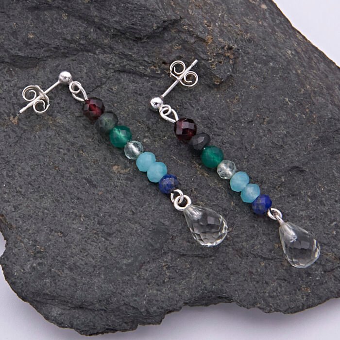 Mixed Gemstone Dangle Earrings on Sterling Silver posts shown from above on a dark grey stone