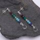 Mixed Gemstone Dangle Earrings on Sterling Silver posts shown from above on a dark grey stone