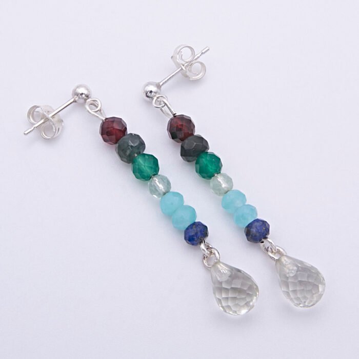 Mixed Gemstone Dangle Earrings on Sterling Silver posts shown from above laid flat on a plain white background, at an angle with posts at the top and amethyst teardrops at the bottom