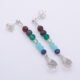 Mixed Gemstone Dangle Earrings on Sterling Silver posts shown from above laid flat on a plain white background, at an angle with posts at the top and amethyst teardrops at the bottom
