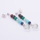 Mixed Gemstone Dangle Earrings on Sterling Silver posts shown laid flat on a white background at an angle with posts at the top and amethyst teardrops at the bottom