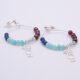 Mixed Gemstone Sterling Silver Hoop Earrings with Cocktail Charms shown laid flat on plain white surface with Cocktail charm towards the bottom