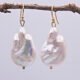 Baroque pear-shaped Freshwater Pearl Earrings shown hanging from twig