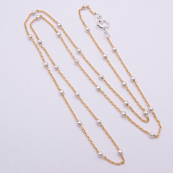 Gold Filled and Sterling Silver Satellite Chain Necklace, shown from above and flat white surface