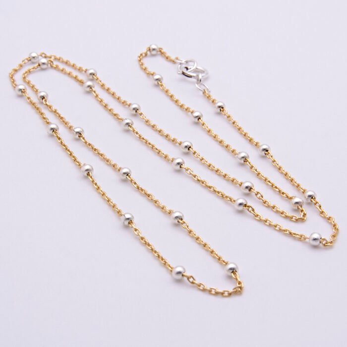 Gold Filled and Sterling Silver Satellite Chain Necklace, shown laid out on plain white background, viewed from above