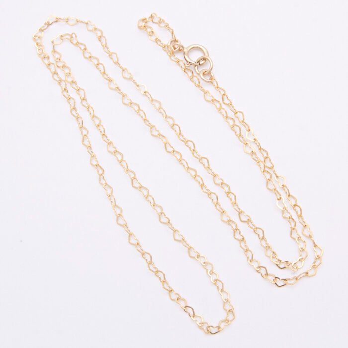 Gold Filled Tiny Hearts Chain Necklace shown viewed from above on plain white background, chain arranged in an N shape