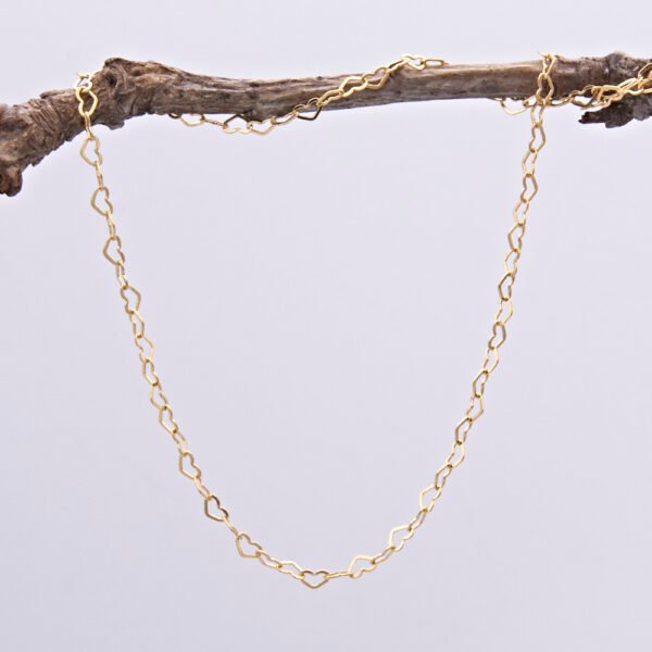 Gold Filled Tiny Heart Link Chain Necklace with spring clasp, shown hanging from twig