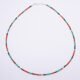 Green Onyx, Carnelian and dark blue Sapphire gemstone necklace with silver clasp shown from above on a plain white background
