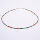 Green Onyx, Carnelian and dark blue Sapphire gemstone necklace with silver clasp shown on plain white background with clasp at the top of the image