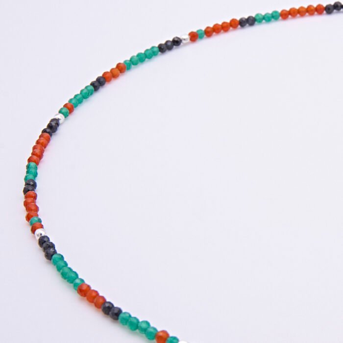 Green Onyx, Carnelian and dark blue Sapphire gemstone necklace with silver clasp, image shows close-up of a beaded section on plain white background