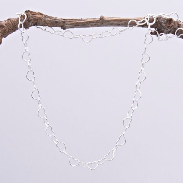 Sterling Silver Heart Link Chain Necklace with spring clasp, shown hanging from twig