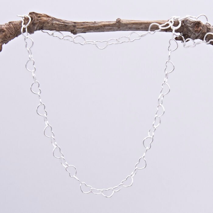 Sterling Silver Heart Link Chain Necklace with spring clasp, shown hanging from twig
