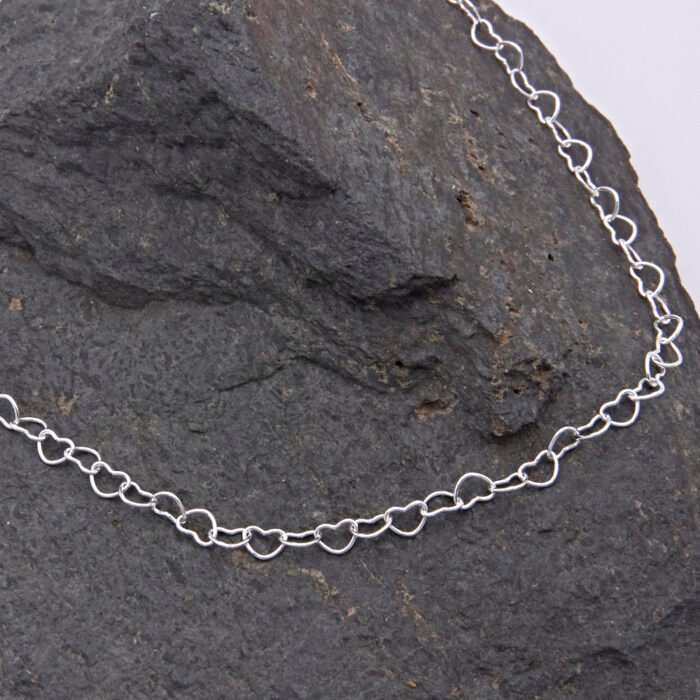 Sterling Silver Heart Link Chain Necklace shown on dark grey stone