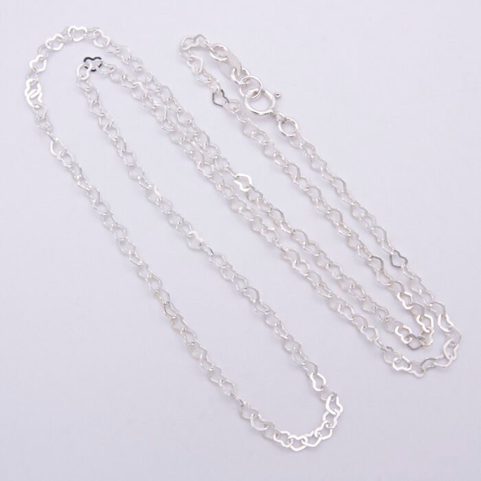 Sterling Silver Small Heart Link Chain Necklace shown close up on flat plain white background looped in a loose N shape