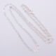 Sterling Silver Small Heart Link Chain Necklace shown close up on flat plain white background looped in a loose N shape