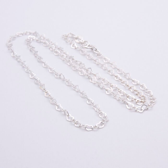 Sterling Silver Small Heart Link Chain Necklace shown on plain white background looped in loose N shape