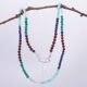 Mixed Gemstone Necklace with Sterling Silver Charm Clasp and Cocktail Charm, shown hanging from twig