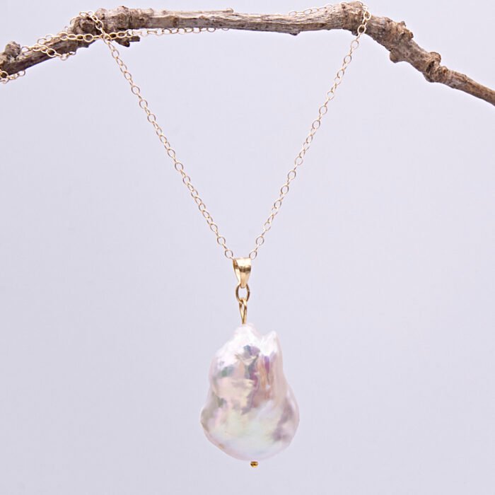 Baroque pear-shaped Freshwater Pearl Necklace shown suspended from twig