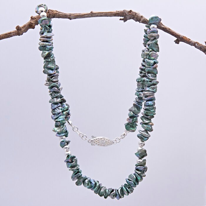 Green Keishi Cornflake Freshwater Pearl and Sterling Silver Necklace, shown hanging from twig