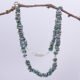 Green Keishi Cornflake Freshwater Pearl and Sterling Silver Necklace, shown hanging from twig