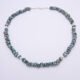 Green Keishi Cornflake Freshwater Pearl and Sterling Silver Necklace, shown from above laid flat on plain white surface, with clasp at the top of the image