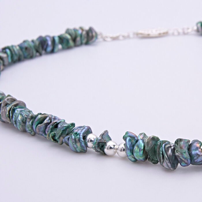 Green Keishi Cornflake Freshwater Pearl and Sterling Silver Necklace, image shows close up of part of pearl strand with sterling silver beads and clasp at the top of the image