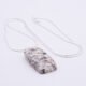Edinburgh Royal Mile Cobblestone Pendant on Sterling Silver Snake Chain, shown on plain white background with chain loosely curved in an N shape, cobblestone pendant is bottom centre of the image