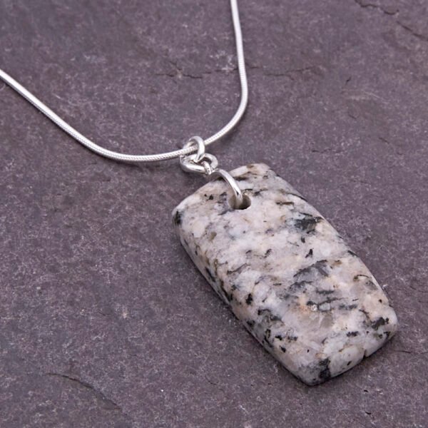 Edinburgh Royal Mile Cobblestone Pendant on Sterling Silver Snake Chain, shown close-up on dark slate