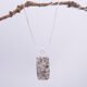 Edinburgh Royal Mile Cobblestone Pendant on Sterling Silver Snake Chain, shown hanging from twig