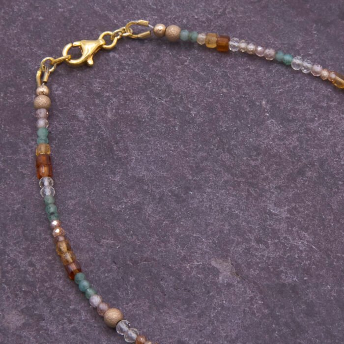 Autumn Colours Mixed Gemstone Gold Vermeil Bracelet, image shows part of gemstone strand and clasp on dark slate background