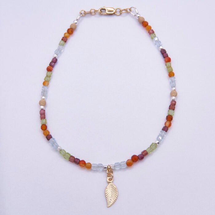Mixed Metals Gemstone Bracelet with Gold Leaf Charm, shown from above on plain white background