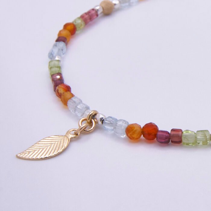 Mixed Metals Gemstone Bracelet with Gold Leaf Charm, image shows close-up of leaf and part of gemstone strand, on plain white background