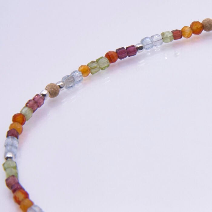 Mixed Metals Gemstone Bracelet with Gold Leaf Charm, image shows close-up of part of gemstone strand, on plain white background