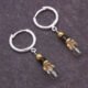 Sterling Silver Hinged Hoop Earrings with Gemstone Dangles, shown from above on dark grey slate background