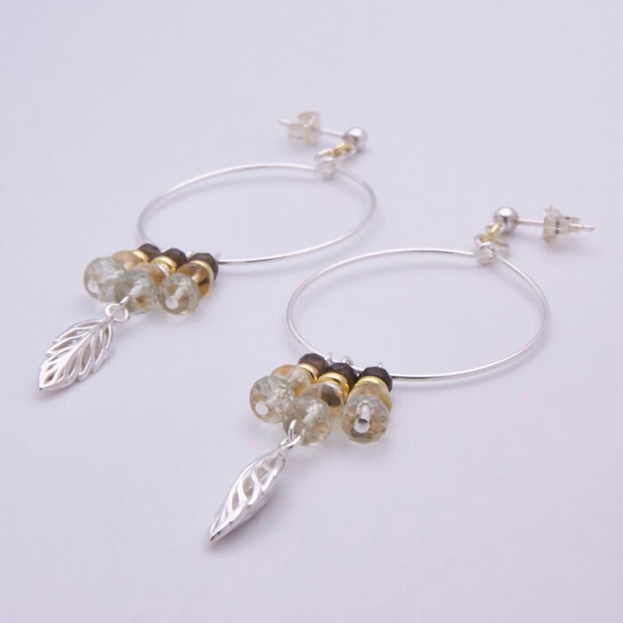 Mixed Metals Leaf Charm Gemstone Hoop Earrings, shown laid at an angle on plain white background