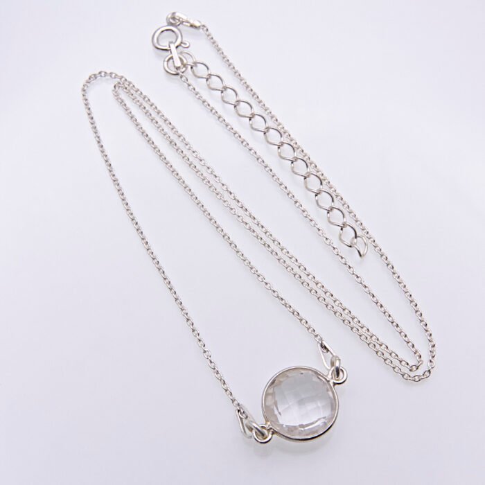 Smoky Quartz or Crystal Quartz round bezel set faceted gemstone Sterling Silver necklace Smoky Quartz or Crystal Quartz round bezel set faceted gemstone Sterling Silver necklace, image shows Crystal Quartz necklace from above on plain white background with gemstone at the bottom of the image