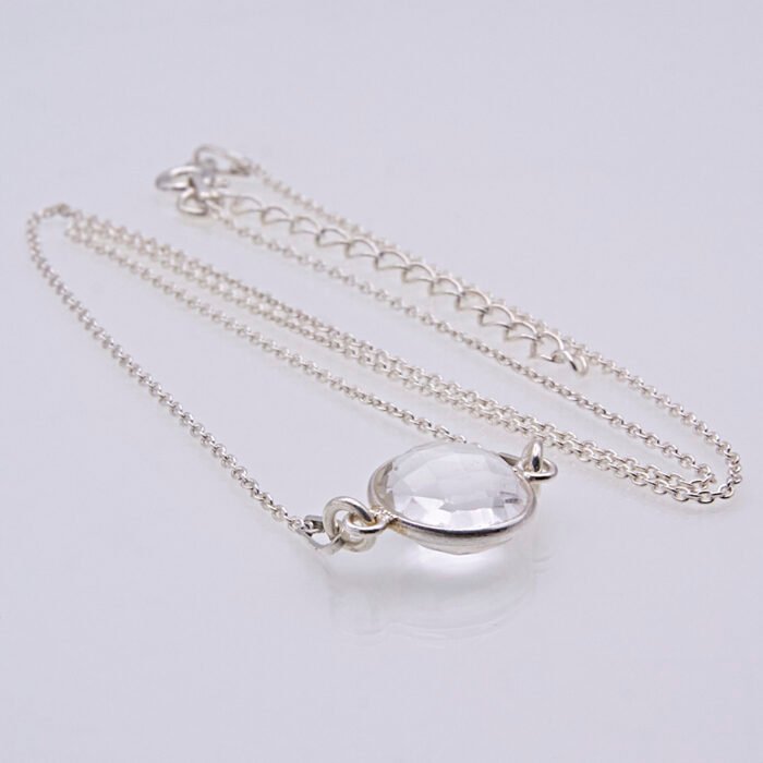 Smoky Quartz or Crystal Quartz round bezel set faceted gemstone Sterling Silver necklace Smoky Quartz or Crystal Quartz round bezel set faceted gemstone Sterling Silver necklace, image shows close-up of Crystal Quartz stone viewed from the side