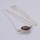 Smoky Quartz or Crystal Quartz round bezel set faceted gemstone Sterling Silver necklace Smoky Quartz or Crystal Quartz round bezel set faceted gemstone Sterling Silver necklace, image shows close-up of Smoky Quartz gemstone viewed from the side
