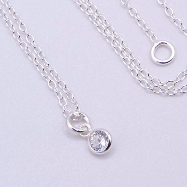 Cubic Zirconia Bezel-set stone on Sterling Silver Chain, image shows close-up of stone on plain white background