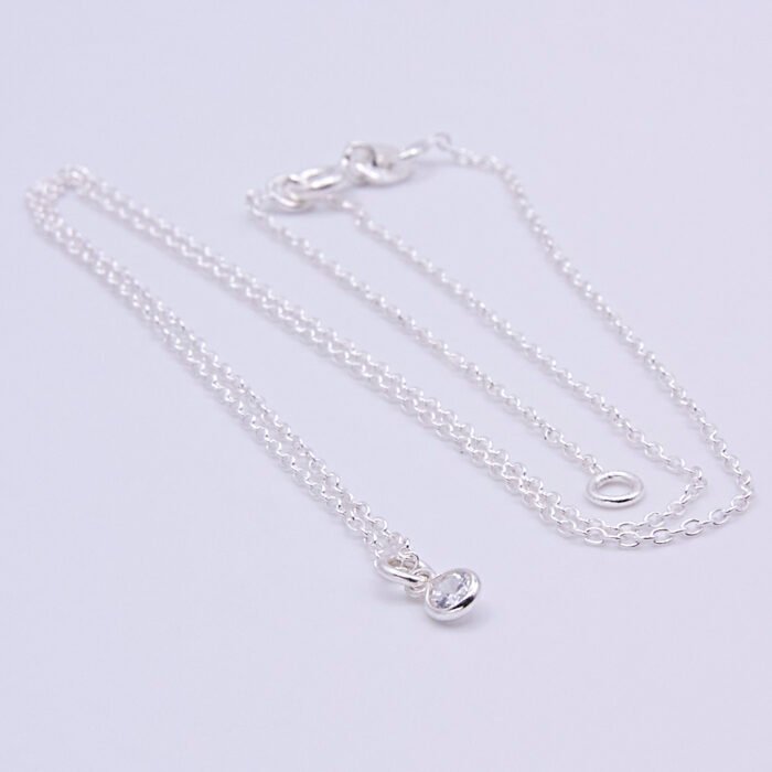 Cubic Zirconia Bezel-set stone on Sterling Silver Chain, image shows necklace on plain white background with the stone at the bottom of the image