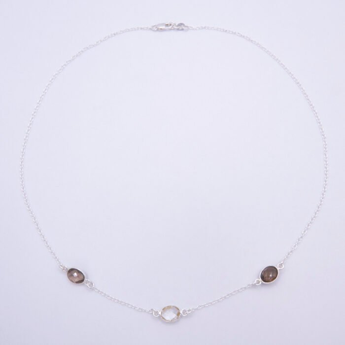 Smoky Quartz and Crystal Quartz 3-stone bezel-set Necklace on Sterling Silver Chain, shown from above on white background, with clasp at the top and stones at the bottom