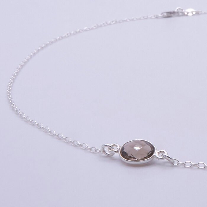 Smoky Quartz and Crystal Quartz 3-stone bezel-set Necklace on Sterling Silver Chain, image shows close-up of Smoky Quartz stone and part of chain, on white background