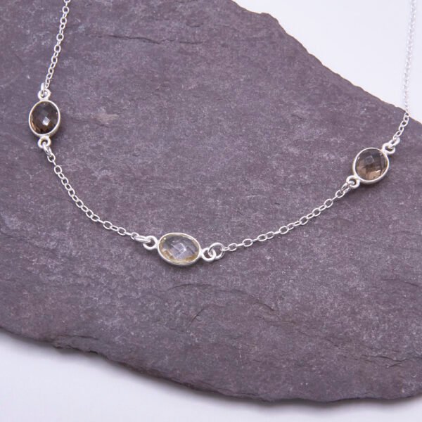 Smoky Quartz and Crystal Quartz 3-stone bezel-set Necklace on Sterling Silver Chain, shown on dark slate background