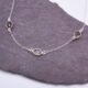 Smoky Quartz and Crystal Quartz 3-stone bezel-set Necklace on Sterling Silver Chain, shown on dark slate background
