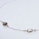 Smoky Quartz and Crystal Quartz 3-stone bezel-set Necklace on Sterling Silver Chain, image shows close up of Smoky Quartz and Crystal Quartz stones and part of chain, on white background
