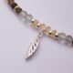 Leaf Charm Mixed Gemstone Necklace, close-up image of leaf and part of gemstone strand on plain white background