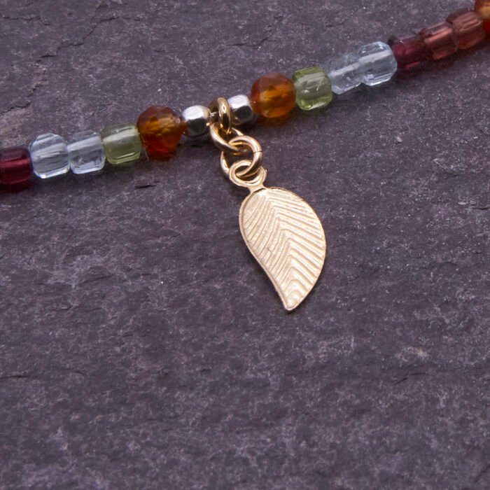Mixed Metals Gemstone Necklace with Gold Leaf Charm, image shows close-up of reverse side of leaf charm