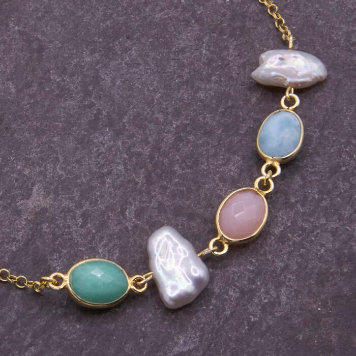 Mixed Bezel-set Pastel Gemstone and Freshwater Pearl Bracelet Mixed Bezel-set Pastel Gemstone and Freshwater Pearl Bracelet, image shows close-up of stones and pearls on dark slate background